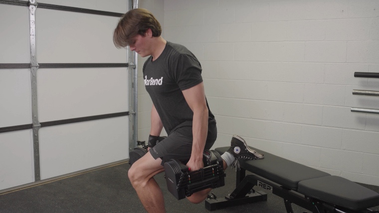 Our tester performing the split squats with the Powerblock Pro 50 Adjustable Dumbbells.