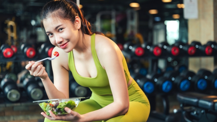 A person eating a pre-workout supplement alternative snack.
