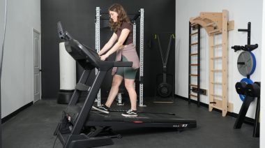 Our tester walking at an incline on the Sole F63 treadmill.