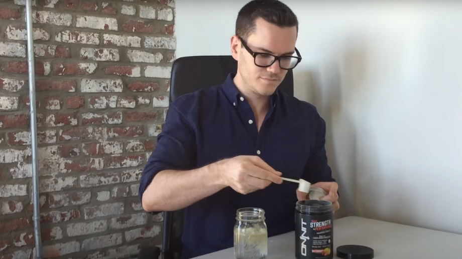 A BarBend tester scooping out Onnit non-stim pre-workout for sampling.