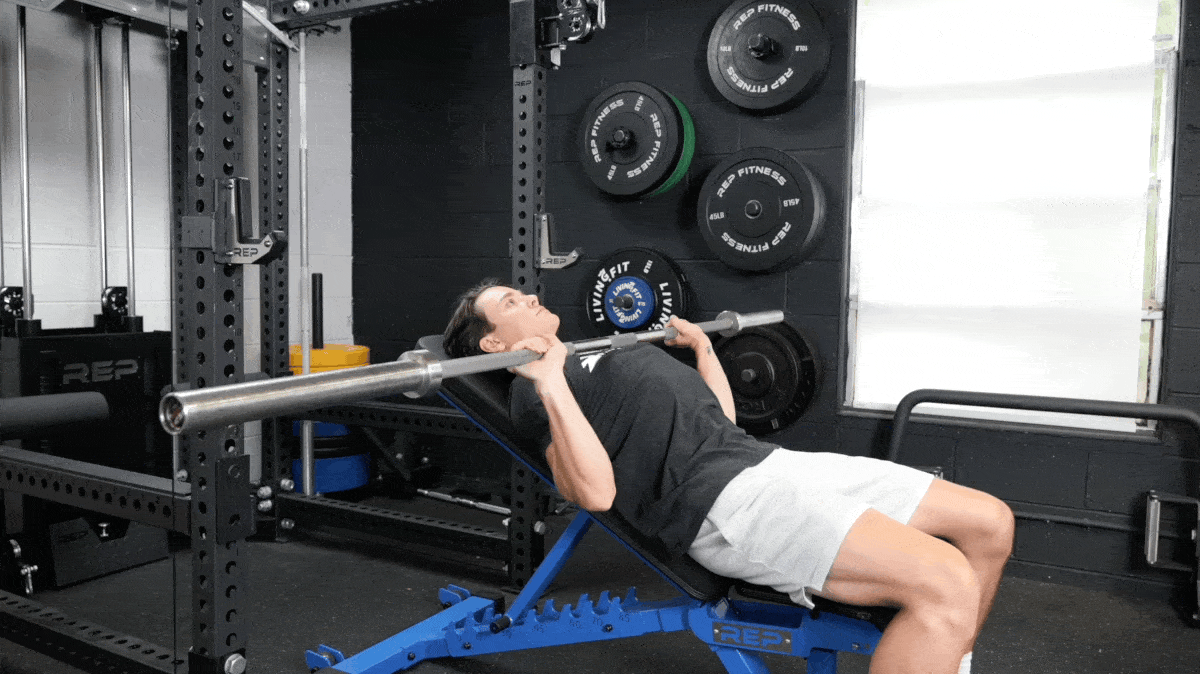 BarBend's Jake Herod performing the incline barbell bench press exercise.