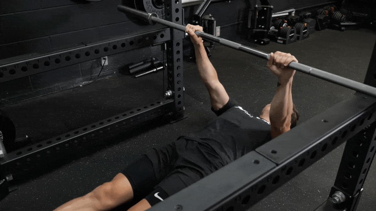 A person performing the inverted row exercise.
