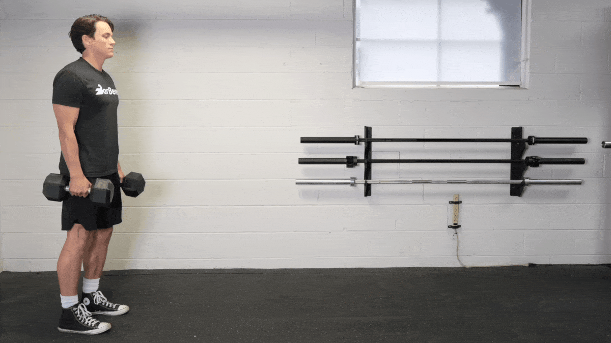 BarBend's Jake Herod performing the farmer's carry exercise.