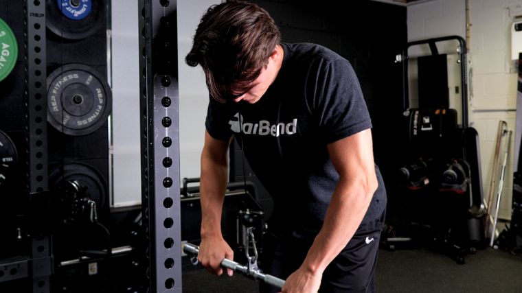 Jake doing cable exercises in the gym. 
